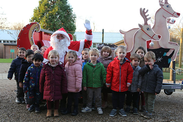 Santa visits the Stamford Nursery School to receive donated gifts from children