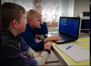 Alex helping his brother with his PowerPoint